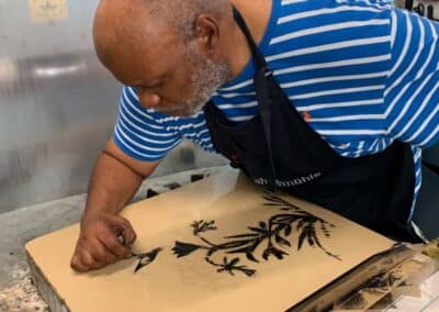 Prof. Joseph Norman working on a Lithography Stone in Black Church Print Studio. B&W Image of a bird on a plant