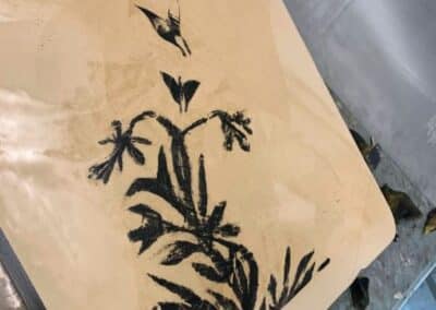 Image of flowers, butterflies and hummingbird drawn onto litho stone